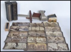 A vintage stereo viewer together with over 40 stereoscopic cards,