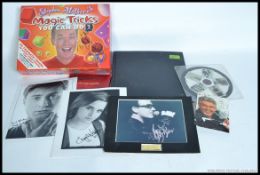A collection of signed items to include a Robbie Williams Book, Emma Watson, Daniel Radcliffe, Bono,