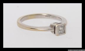 An 18ct / 750 white gold and diamond ring with a single square cut diamond of .20pts.