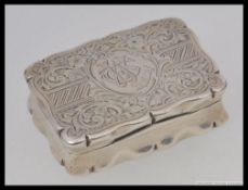 A good sized silver hallmarked stamp box being of casket / book form with rococo chased decoration,