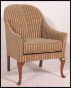 A mid century Queen Anne revival armchair.