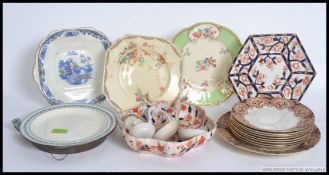 A collection of Victorian and later period plated along with ceramic ladles and a plate warmer.