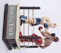 BOXING MONEY BOX: A 20th century vintage style cast iron money box in the form of a boxing ring,