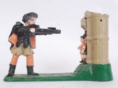 MONEY BOX: A 20th century reproduction shooting themed cast iron painted money box.