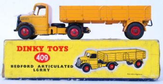 DINKY: An original vintage Dinky Toys boxed diecast model 409 Bedford Articulated Lorry, in yellow.