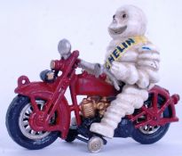 MICHELIN MAN: A vintage style cast iron Michelin Man and motorcycle figure. Hand painted.
