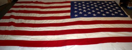 A Vietnam period large ( capital ship size ) American flag being machine stitched with hand
