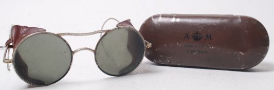 A pair of wire framed aviation pilots glare glasses with the original Air Ministry tin,