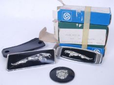 JAGUAR NOS: A collection of three new-old-stock unused Jaguar car badges - each with the original