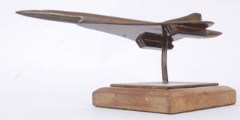 A fabulous 20th century bronze / brass model of Concorde. Mounted on a wooden plinth base.