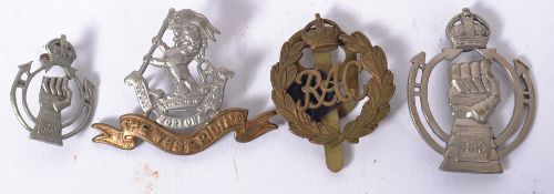 A collection of military cap badges to  include The West Riding Regiment,