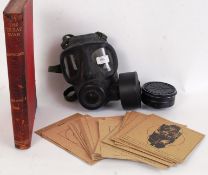 MILITARIA: A collection of assorted militaria to include a vintage gas mask,