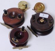 A collection of antique and vintage fishing reels to include a Wooden Starback,