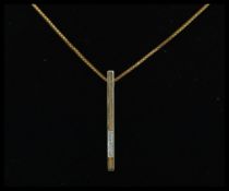 A 9ct gold and diamond drop pendant set