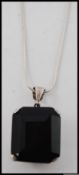 A large silver and smokey quartz pendant