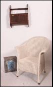 A Lloyd Loom style whicker armchair toge