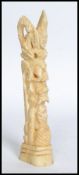 A 20th century carved bone totem statue.