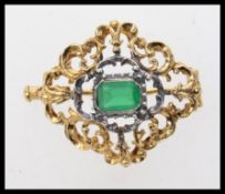 A rococo style  silver brooch with gilde