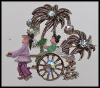 A 1950s white metal and enamel brooch wi