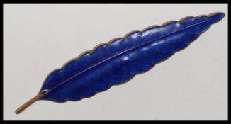 A vintage blue enamel brooch in the shap