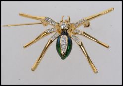 A vintage yellow metal and green enamel