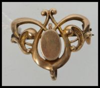 A yellow metal watch clip brooch marked