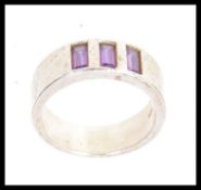 A 925 silver ring set with three amethys