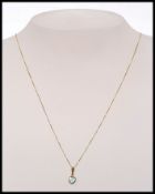A 9ct gold pendant necklace set with a h