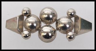 A 1930s Art Deco white metal cloak cape