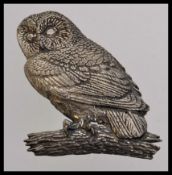 A vintage white metal brooch of an owl p