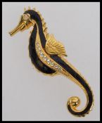 A large vintage yellow metal seahorse br