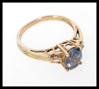 A plated dress ring with central amethys