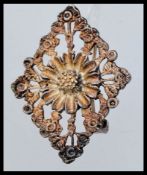 A vintage silver brooch decorated with a