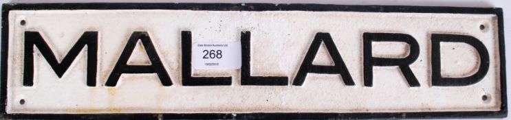 A reproduction miniature cast iron sign