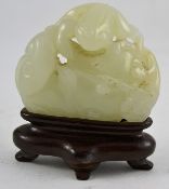 A stunning Chinese Jade carving of a frog set on a leaf and stone complete with a wooden plinth