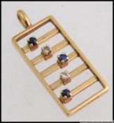 A stunning 9ct gold diamond and sapphire abacus necklace pendant by E J Clewley & Co Ltd.