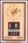 A vintage mid century teak wood retro block date and month wall clock with notation for Barclays