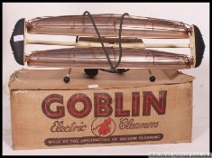 A vintage mid century Goblin hoover in the original box of atomic style together with a retro