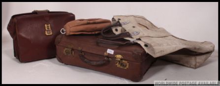 A collection of vintage leather suitcases and bags along with floor to ceiling gym ball