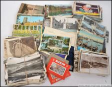 A box of postcards to include early 20th century examples to include seascapes, lake district,