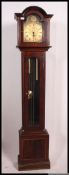 A 20th century mahogany tempus fugit longcase clock with decorative face,