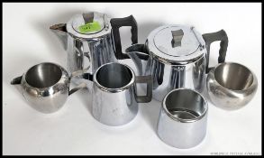 A retro 1960's stainless steel tea service consisting of teapot, water pot, creamer, sugar bowl etc.