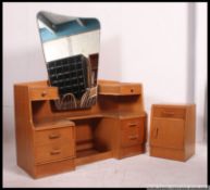a 1960's pale oak Ernest Gomme for G-Plan dressing table having drop centre with dressing mirror