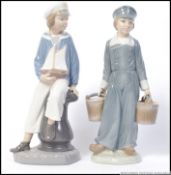 Two Lladro figures Dutch Boy Carrying Milk Pails and Sailor Boy Holding Model Yacht both stamped