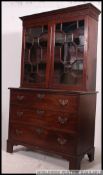 An 18th century Georgian mahogany bookcase on chest of drawers.