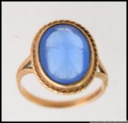 A vintage large ladies 9ct gold and blue sapphire style stone set dress ring.
