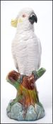 A 19th century Minton majolica figurine of a Cockatoo being raised on a naturalistic plinth base.