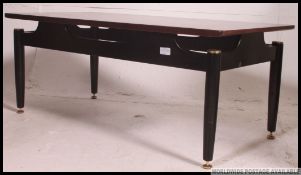 A 1970's Retro G-Plan Librenza coffee - occasional table raised on ebonised legs with suspension