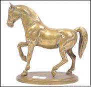 A good mid century brass cast figure of cantering / prancing horse mounted on a brass base
