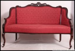 An Edwardian mahogany show wood framed 2 seat salon sofa settee raised on cabriole legs with rococo
